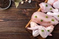 Raw chicken meat on dark wooden background