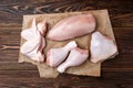 Raw chicken meat on dark wooden background