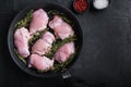 Raw chicken meat on pan on black backgroundtop viewwith space for text