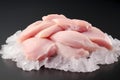 Raw chicken meat and chicken wings placed on ice.