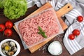 Raw chicken minced meat and ingredients on wooden table, flat lay Royalty Free Stock Photo