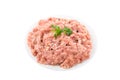 Raw chicken minced meat in a plate with herbs and spices isolated on white background