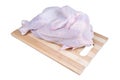 Raw chicken relaxing on a board