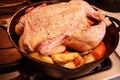 Raw chicken, seasoned and placed on top of vegetables and ready to be roasted in cast iron skillet. Royalty Free Stock Photo