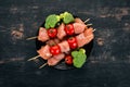 Raw chicken skewers with tomatoes and vegetables. Kebab. On a wooden background. Royalty Free Stock Photo