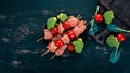 Raw chicken skewers with tomatoes and vegetables. Kebab. On a wooden background. Royalty Free Stock Photo