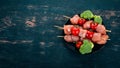 Raw chicken skewers with tomatoes and vegetables. Kebab. On a wooden background. Royalty Free Stock Photo