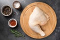 Raw chicken thigh on wooden cutting board Royalty Free Stock Photo