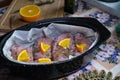 Raw chicken turkey fillet covered with herbs and orange slices in oven tray prepared for roasting. Royalty Free Stock Photo