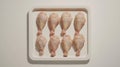 Raw chicken wings arranged on a white tray ready for cooking or grilling Royalty Free Stock Photo