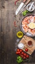 Raw chicken wings in barbecue sauce in a pan with vegetables, spices on wooden rustic background top view close up Royalty Free Stock Photo