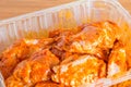 Raw chicken wings in mexican sauce in plastic pack