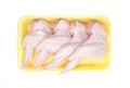 Raw Chicken wings in a yellow polystyrene container isolated on white background. Four fresh chicken parts for cooking. Top view.