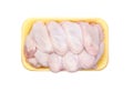 Raw Chicken wings in a yellow polystyrene container isolated on white background. Set of Eight fresh chicken parts for cooking. To