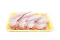 Raw Chicken wings in a yellow polystyrene container isolated on white background. Four fresh chicken parts for cooking. Side view.