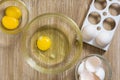 Raw chicken yolks and whites in glass bowl on wooden table Royalty Free Stock Photo