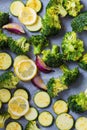 Raw chopped broccoli, zucchini, and onions on baking sheet. Cooking green vegetables for baking in the oven. Cooking healthy food Royalty Free Stock Photo