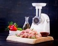 Raw chopped chicken breast fillets on wooden cutting board and meat grinder. Royalty Free Stock Photo
