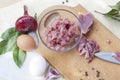 Raw chopped pork tenderloin with herbs in a glass bowl on a wooden board Royalty Free Stock Photo