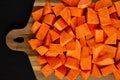 Raw Chopped Sweet Potatoes on a Cutting Board, top view. Flat lay, overhead, from above Royalty Free Stock Photo