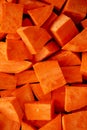 Raw Chopped Sweet Potatoes on a Cutting Board, top view. Flat lay, overhead, from above Royalty Free Stock Photo