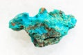 raw Chrysocolla stone on white marble