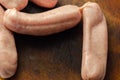 Raw classic British sausage made from prime cuts of pork on the wooden board