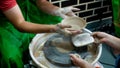 A raw clay pot in the hands of a potter. Workshop in the pottery workshop Royalty Free Stock Photo