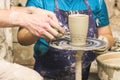 A raw clay pot in the hands of a potter. Workshop in the pottery Royalty Free Stock Photo