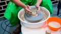 A raw clay pot in the hands of a potter. Workshop in the pottery workshop Royalty Free Stock Photo