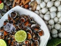 Raw cockles, fishballs, sausages and prawns.