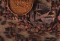 Raw cocoa beans, clay bowl with cocoa powder, chocolate on sack