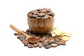 Raw cocoa beans in wooden bowl, cocoa butter and spoon with cocoa powder.