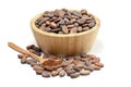 Raw cocoa beans in wooden bowl and spoon with cocoa powder. Royalty Free Stock Photo