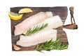 Raw cod fish fillets, codfish with rosemary on wooden board. Isolated, white background. Royalty Free Stock Photo