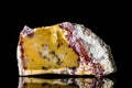 Raw colorful quartz and agate mineral stone in front of black background