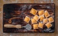 Raw colourful Ravioli with pumpkin and paprika on a wooden Board