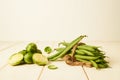 Raw Green beans tied with at string and Brussel sprouts placed on wooden table Royalty Free Stock Photo