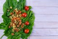 Raw conchiglie pasta with spinach and tomato. Italian Cuisine. Vegan food. Top views, close-up Royalty Free Stock Photo