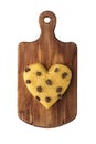 Raw cookie dough with chocolate chips in the shape of a heart on a cutting board, top view. Royalty Free Stock Photo