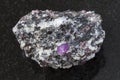 raw corundum crystals in gneiss stone on dark Royalty Free Stock Photo
