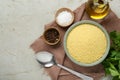 Raw couscous and ingredients on light table, flat lay. Space for text Royalty Free Stock Photo