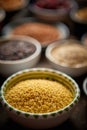 Raw couscous seeds in ceramic bowl. Selective focus Royalty Free Stock Photo