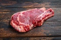 Raw cowboy or rib eye steak on the bone. Marble beef meat ribeye. Dark wooden background. Top view Royalty Free Stock Photo