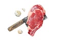 Raw cowboy or rib eye steak on the bone on a meat cleaver. Marble beef meat ribeye. Isolated on white background. Top Royalty Free Stock Photo