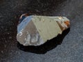 Raw crystal of Cassiterite stone on black Royalty Free Stock Photo