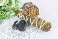 Raw crystal healing black tourmaline and white sages herb sticks for clearing negative energy on Metraton cube. Mind and soul