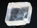 raw crystal of Iceland spar gemstone on dark