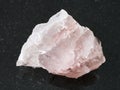 raw crystal of rose quartz gemstone on dark Royalty Free Stock Photo