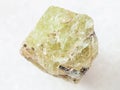 raw crystal of Saamite (fluorapatite) on white